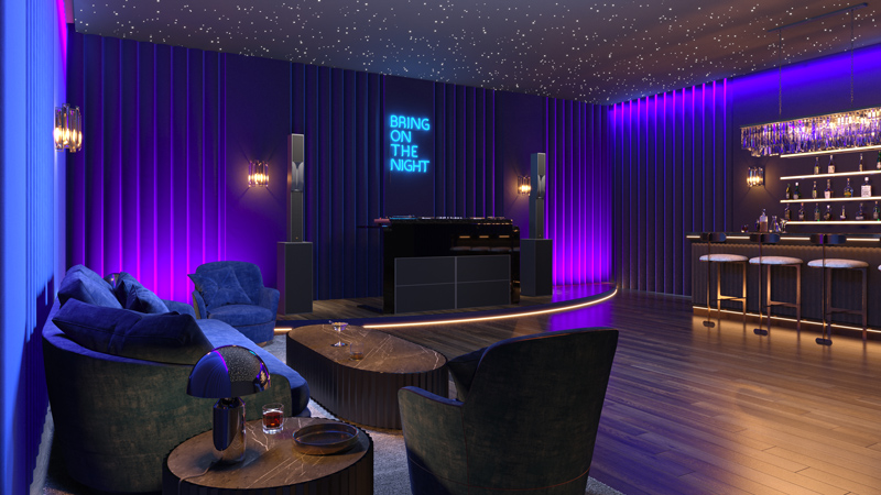 A modern lounge with blue and purple lighting feels like a home nightclub, featuring cozy armchairs, a bar with stools, and a DJ booth. The starry night ceiling and neon BRING ON THE NIGHT sign set the scene as drinks await on the tables.